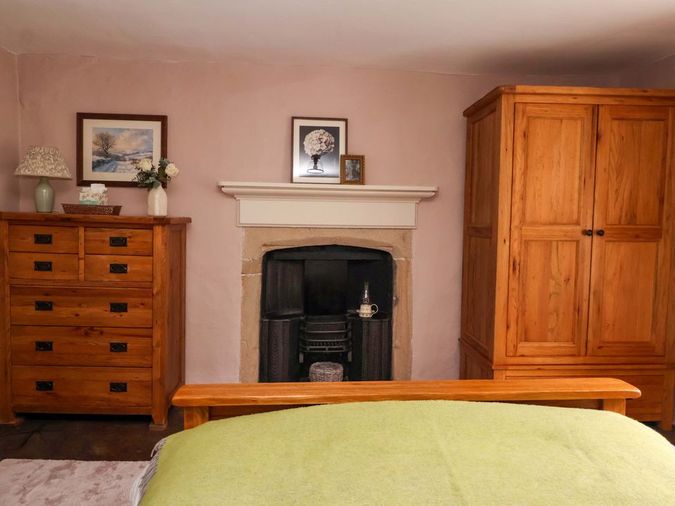 A bedroom with a bed and dresser at Ellis House in Skipton