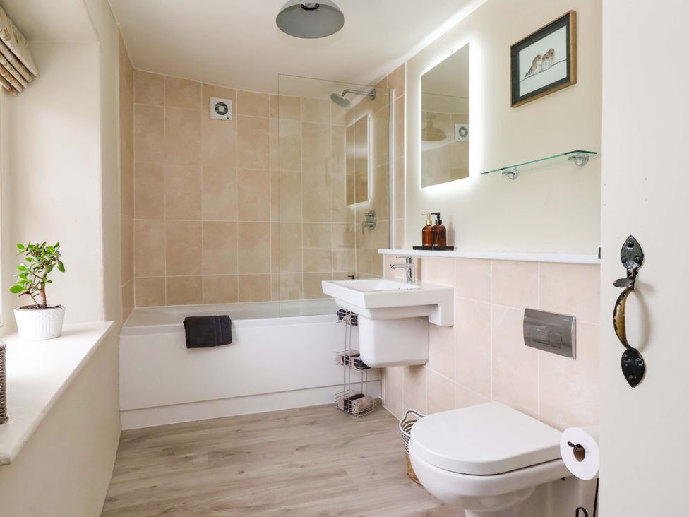 A bathroom with a bathtub, sink, and toilet at Ellis House in Skipton