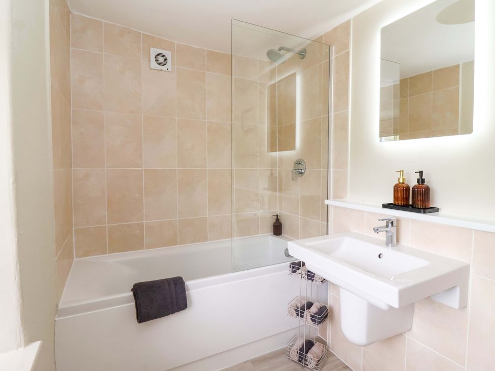A bathroom with a bathtub and sink at Ellis House Skipton