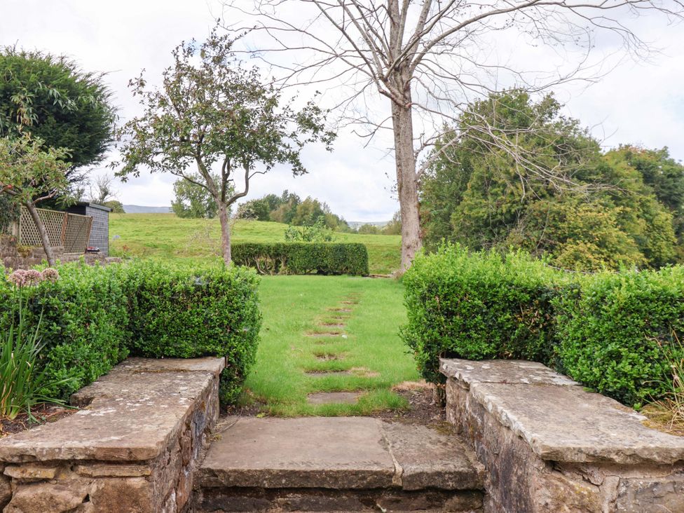 A garden with steps leading to a grassy area at Ellis House in Skipton