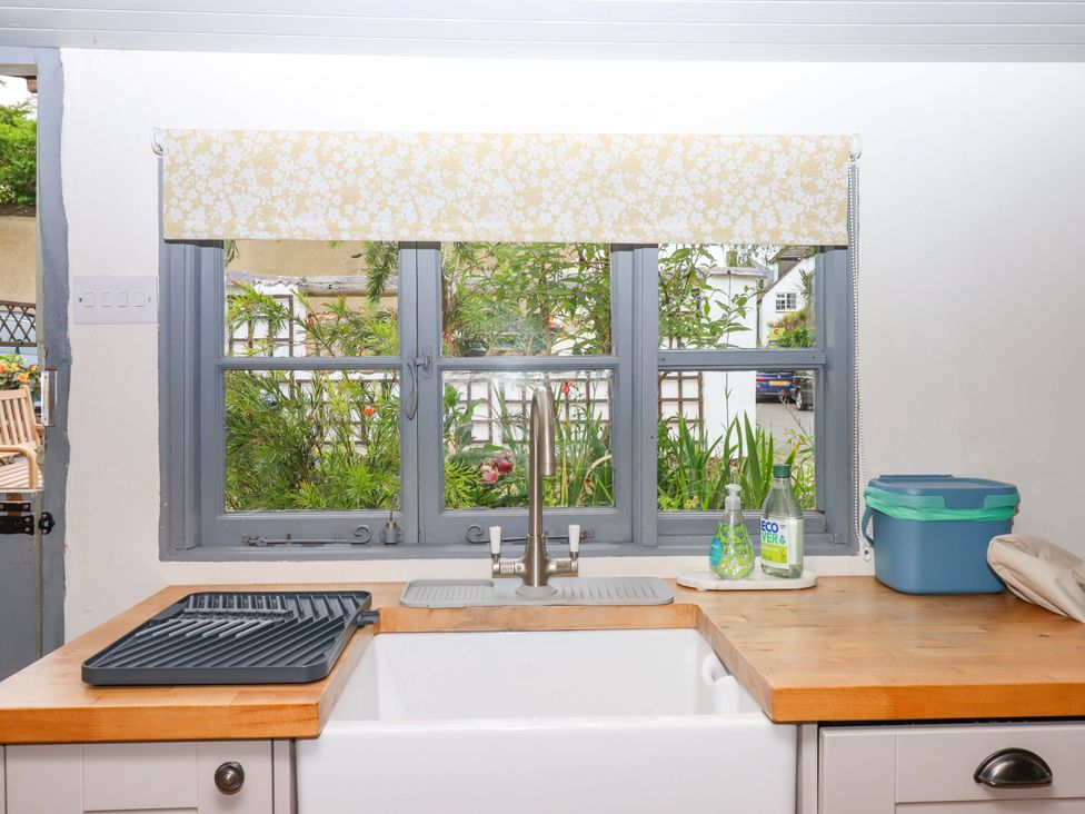 A kitchen with a window and sink at 1 Myrtle Cottages in Stokeinteignhead