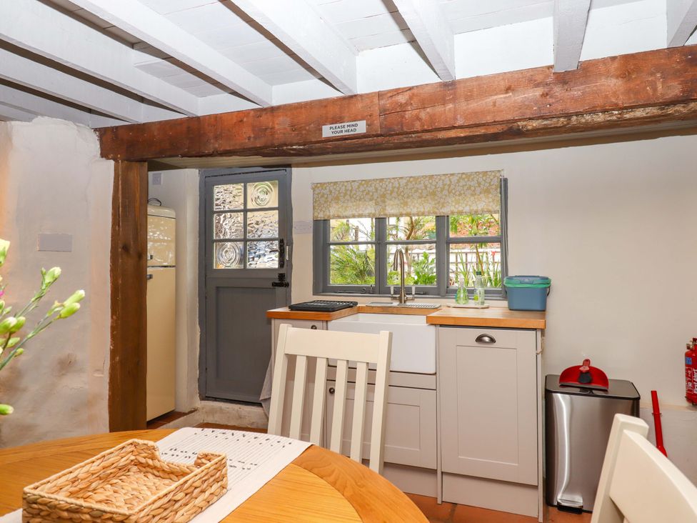 A kitchen with a sink and refrigerator at 1 Myrtle Cottages Stokeinteignhead