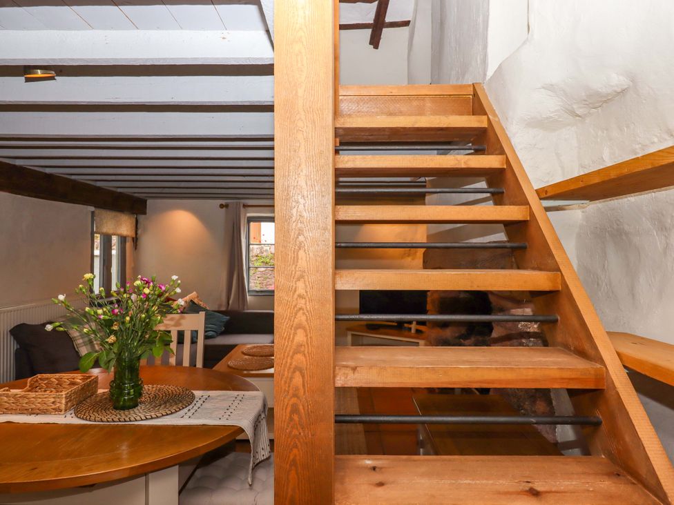 A room with a staircase and dining area at 1 Myrtle Cottages Stokeinteignhead