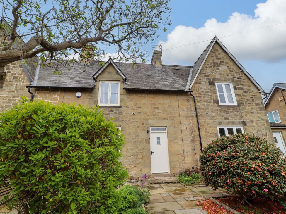 A house with a front door and windows at 9 Longhirst Village Morpeth