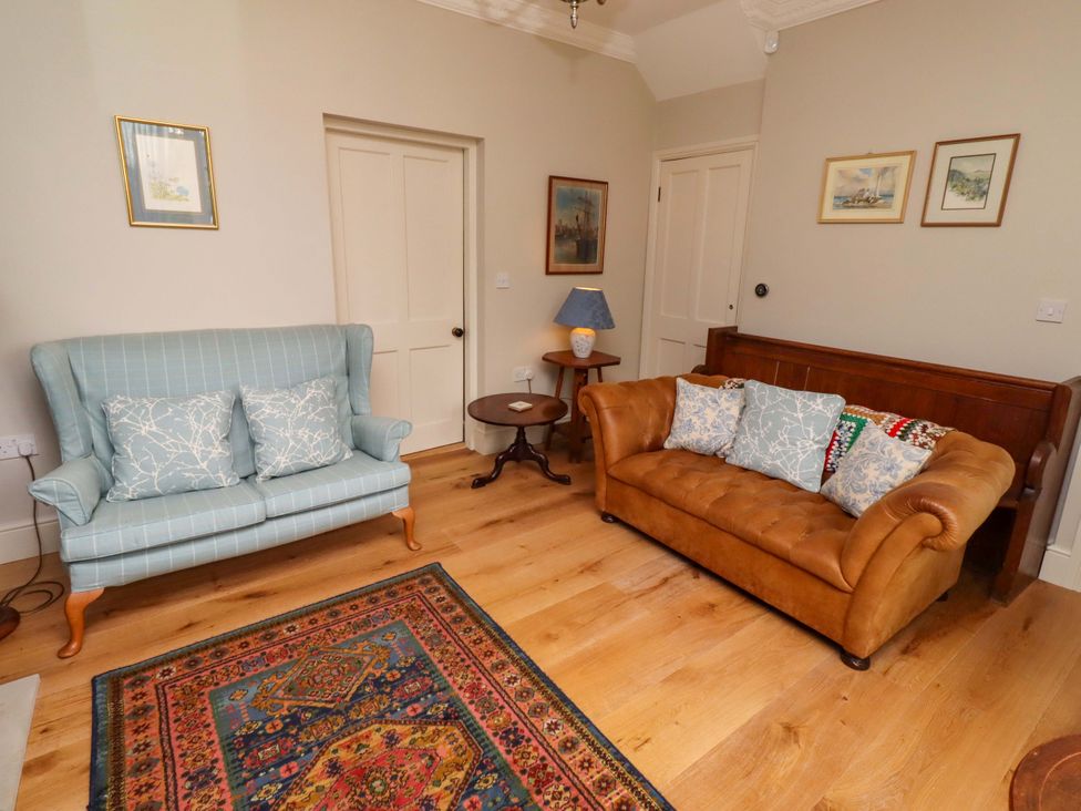 A living room with two sofas and a coffee table at 9 Longhirst Village in Morpeth