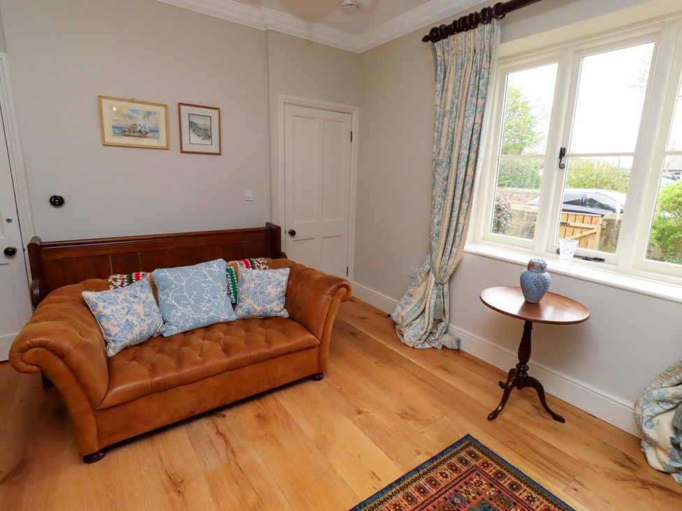 A living room with a couch and side table at 9 Longhirst Village in Morpeth