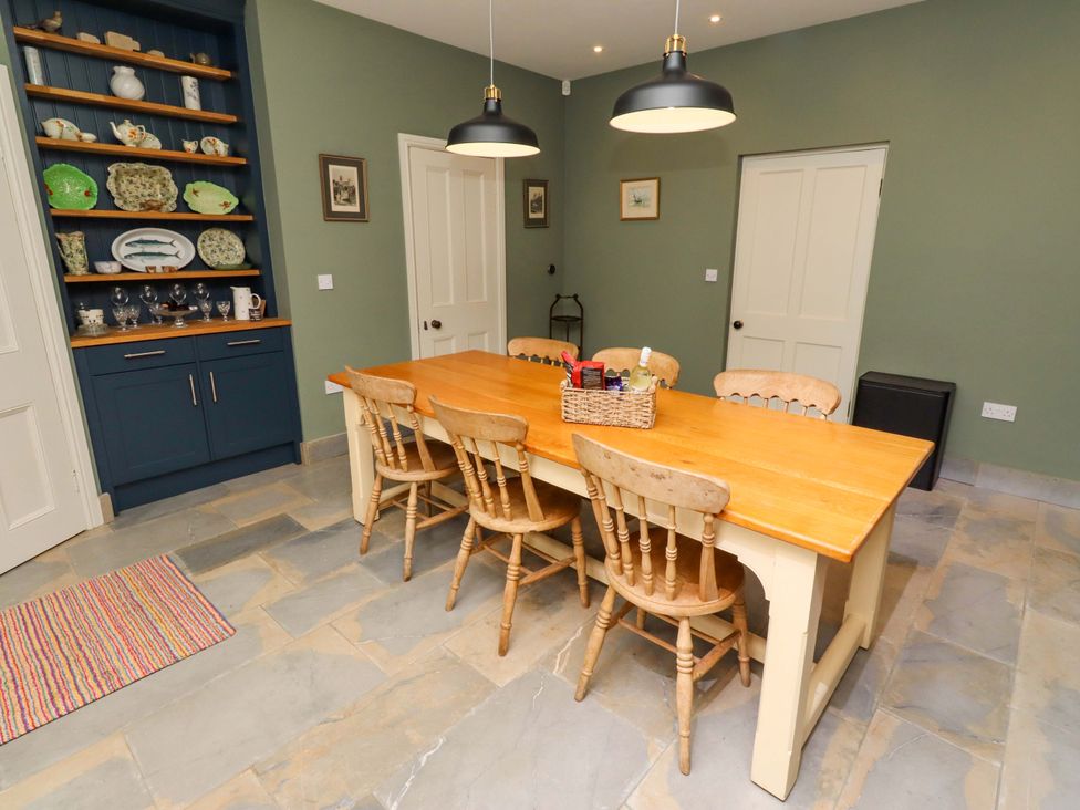A dining room with a table and chairs at 9 Longhirst Village Morpeth