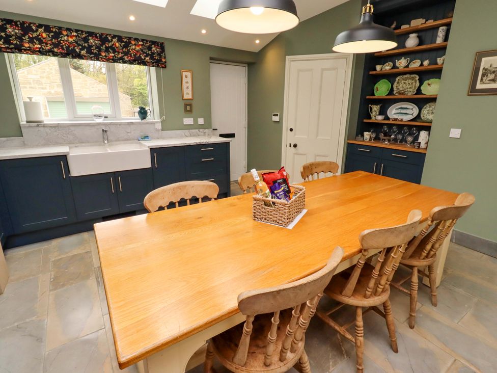 A kitchen with a dining table and sink at 9 Longhirst Village in Morpeth
