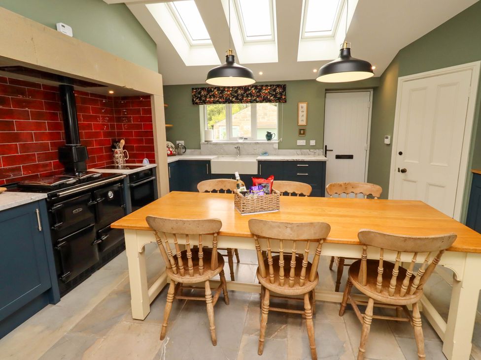 A kitchen with a dining table and chairs at 9 Longhirst Village, Morpeth