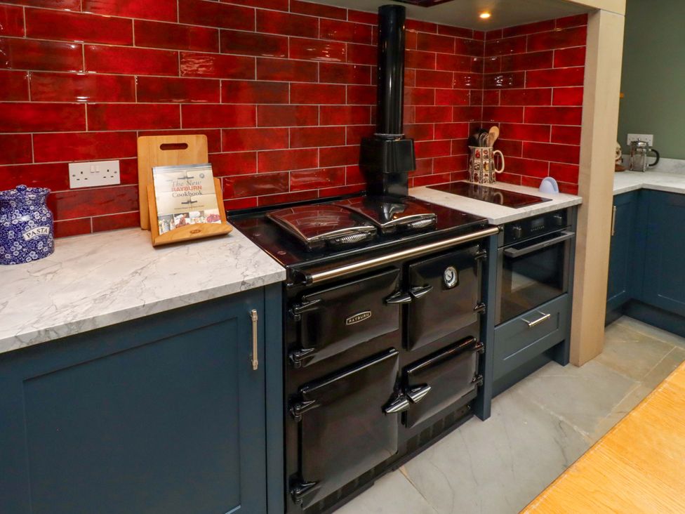 A kitchen with an oven and cooktop at 9 Longhirst Village Morpeth