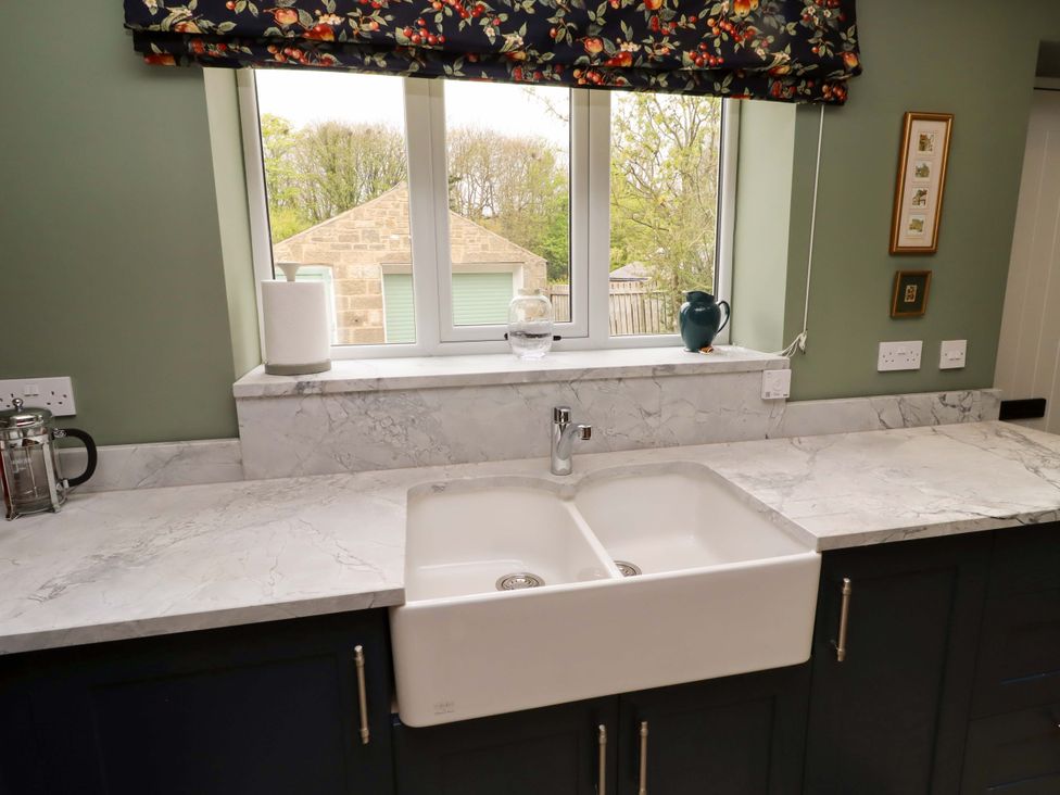 A kitchen with a sink and window at 9 Longhirst Village Morpeth