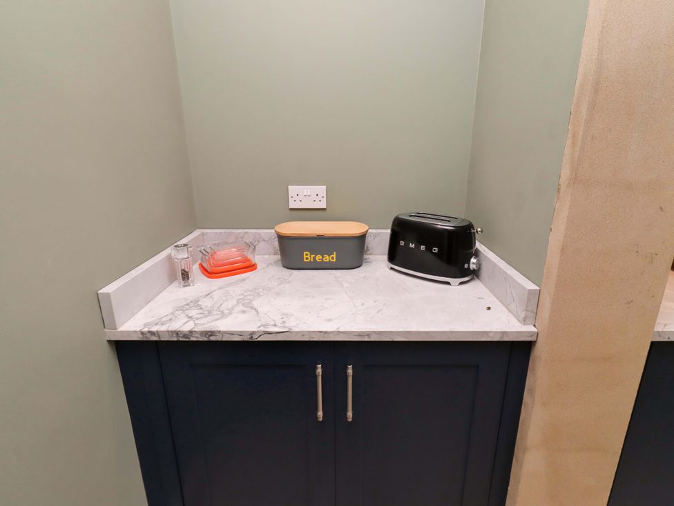 A kitchen countertop with a toaster and storage containers at 9 Longhirst Village Morpeth