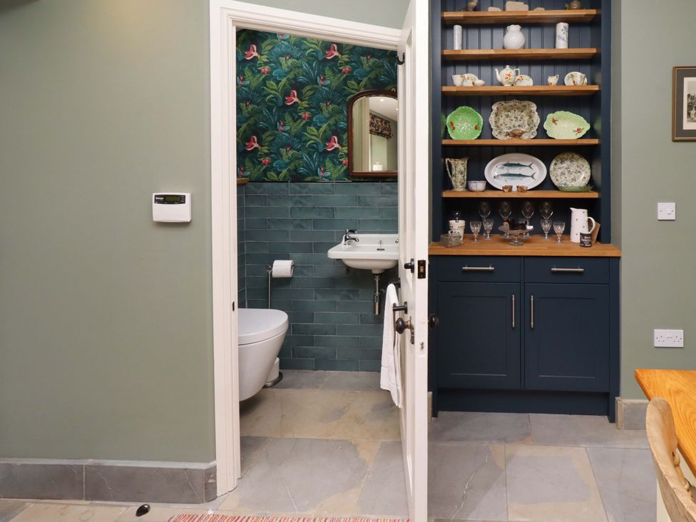 A bathroom with a toilet and sink visible at 9 Longhirst Village Morpeth