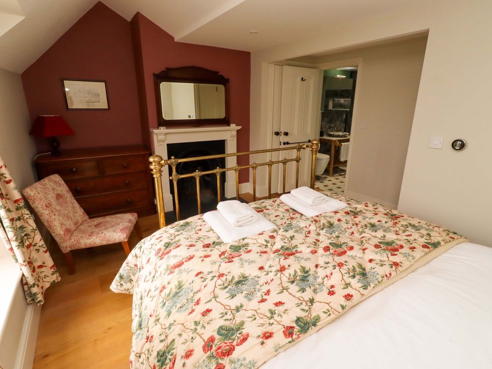 A bedroom with a bed and dresser at 9 Longhirst Village in Morpeth