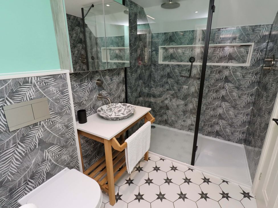 A bathroom with a shower and sink at 9 Longhirst Village in Morpeth