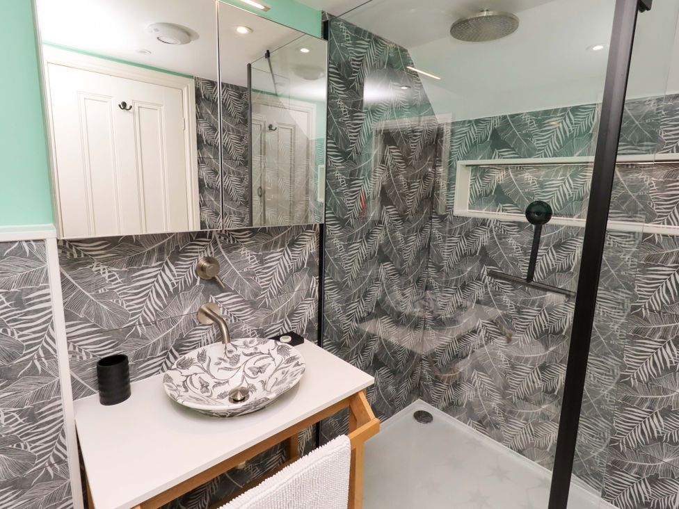 A bathroom with a sink and shower at 9 Longhirst Village in Morpeth
