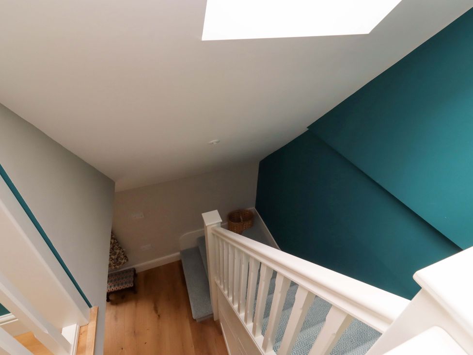 A staircase with a handrail and a basket at 9 Longhirst Village Morpeth