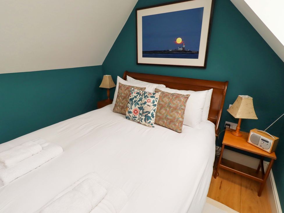 A bedroom with a bed and nightstand at 9 Longhirst Village Morpeth