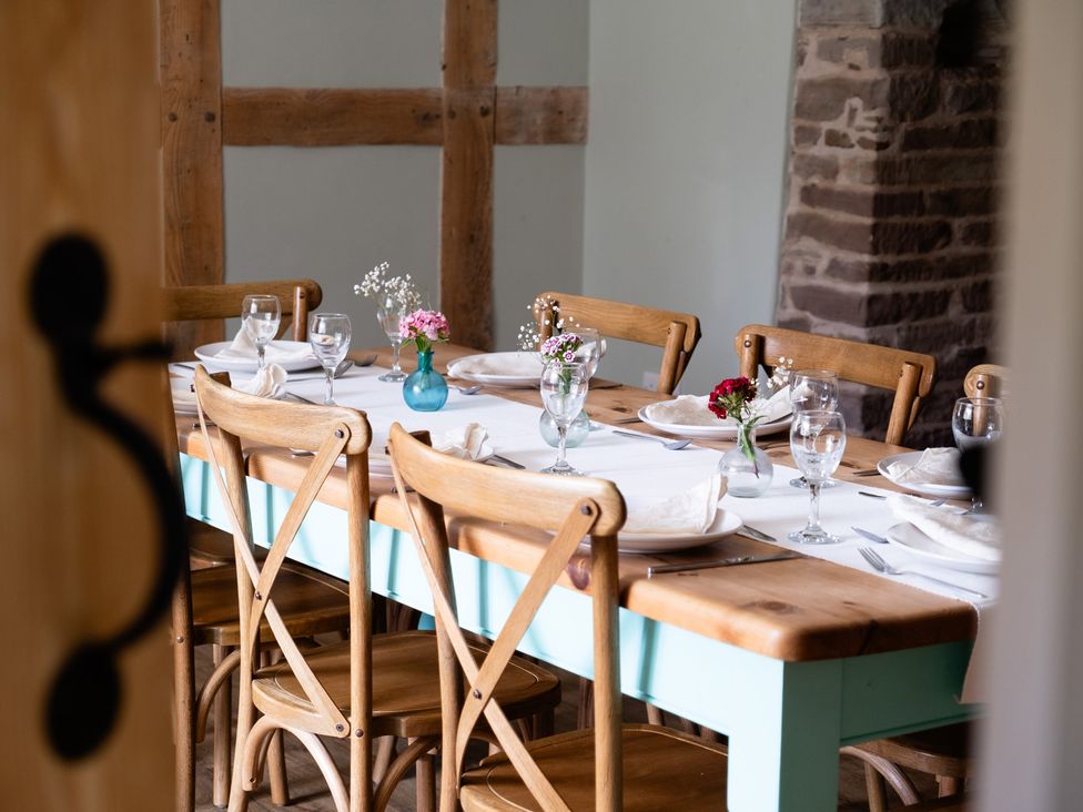 A dining room with a set table at Henhouse Farm in Bodenham