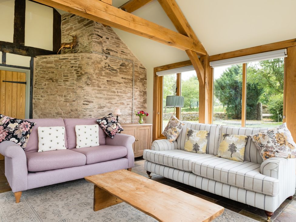 A living room with sofas and a coffee table at Henhouse Farm in Bodenham