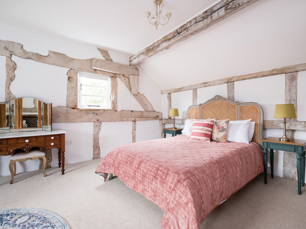 A bedroom with a bed and dressing table at Henhouse Farm in Bodenham