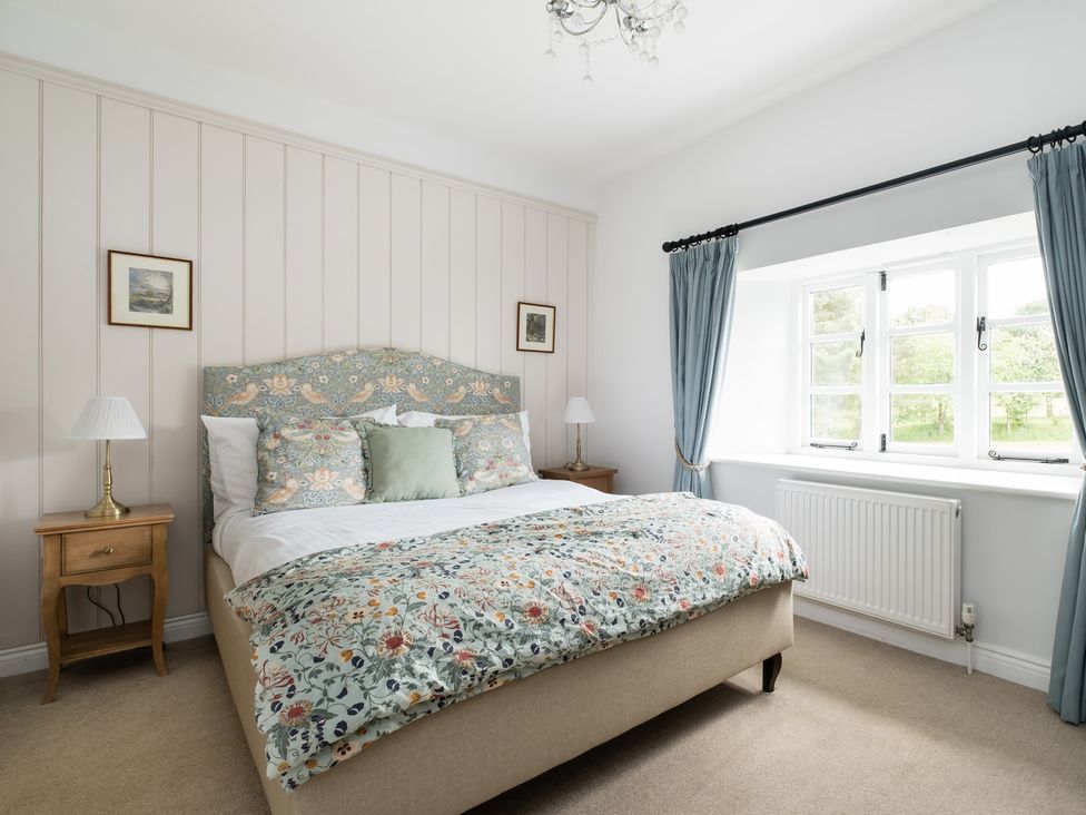 A bedroom with a bed and bedside table at Henhouse Farm in Bodenham