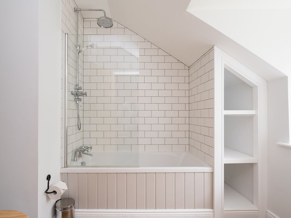 A bathroom with a bathtub and shower at Henhouse Farm in Bodenham
