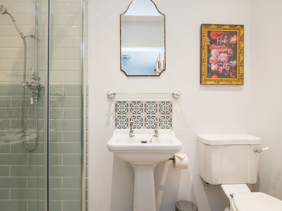 A bathroom with a shower, sink, and toilet at Henhouse Farm in Bodenham