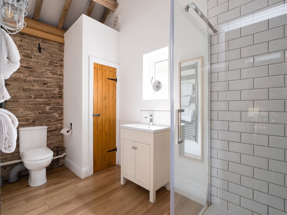 A bathroom with a shower and sink at Henhouse Farm in Bodenham