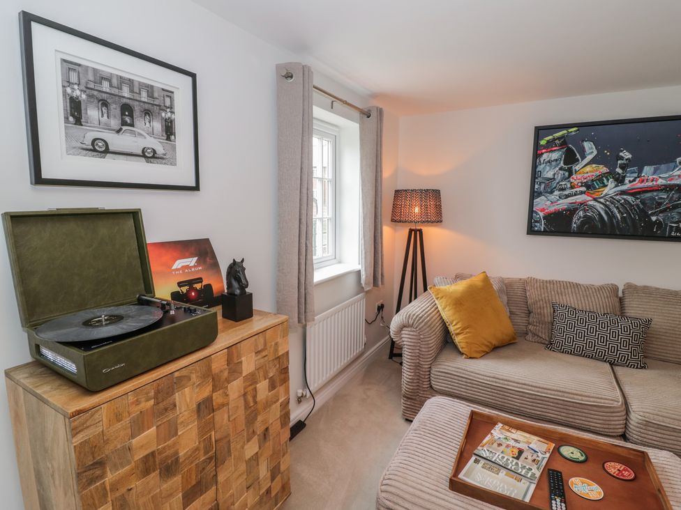 A living room with a record player and sofa at Silverstone Paddock Retreat in Silverstone