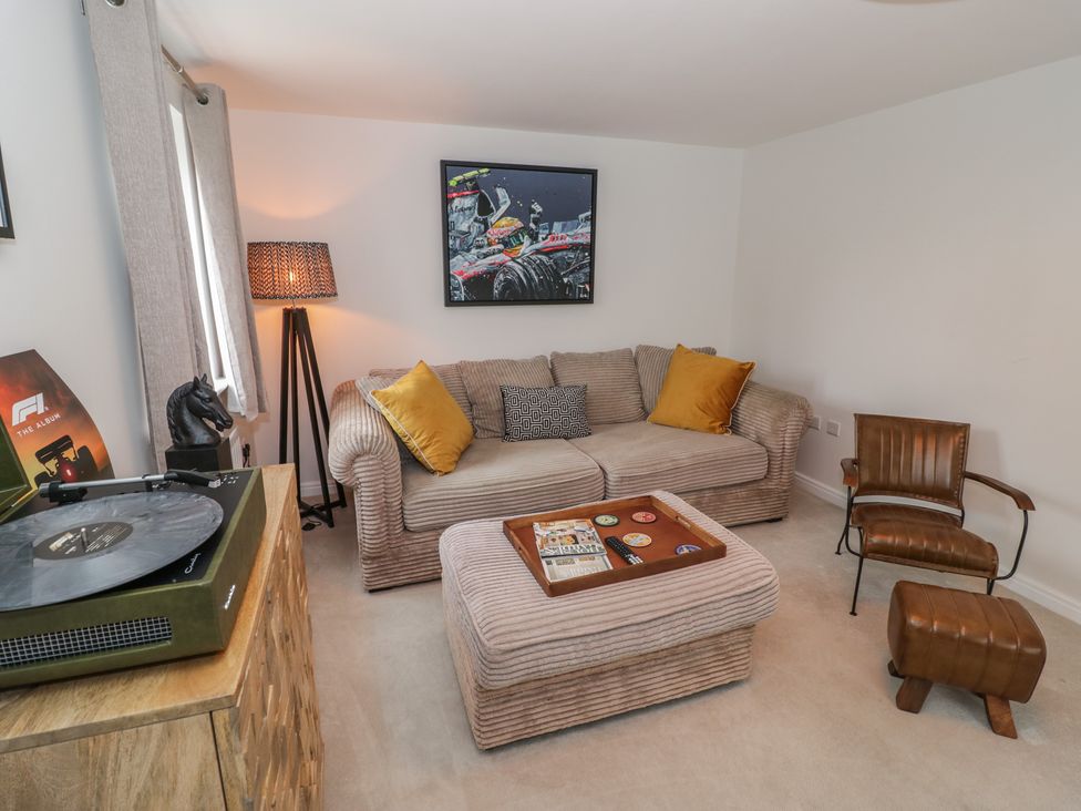 A living room with a sofa and coffee table at Silverstone Paddock Retreat in Silverstone