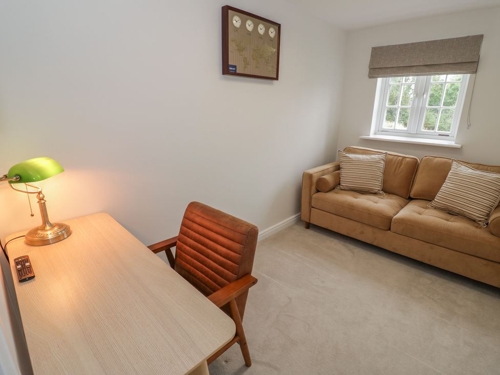 An office with a desk and a sofa at Silverstone Paddock Retreat in Silverstone