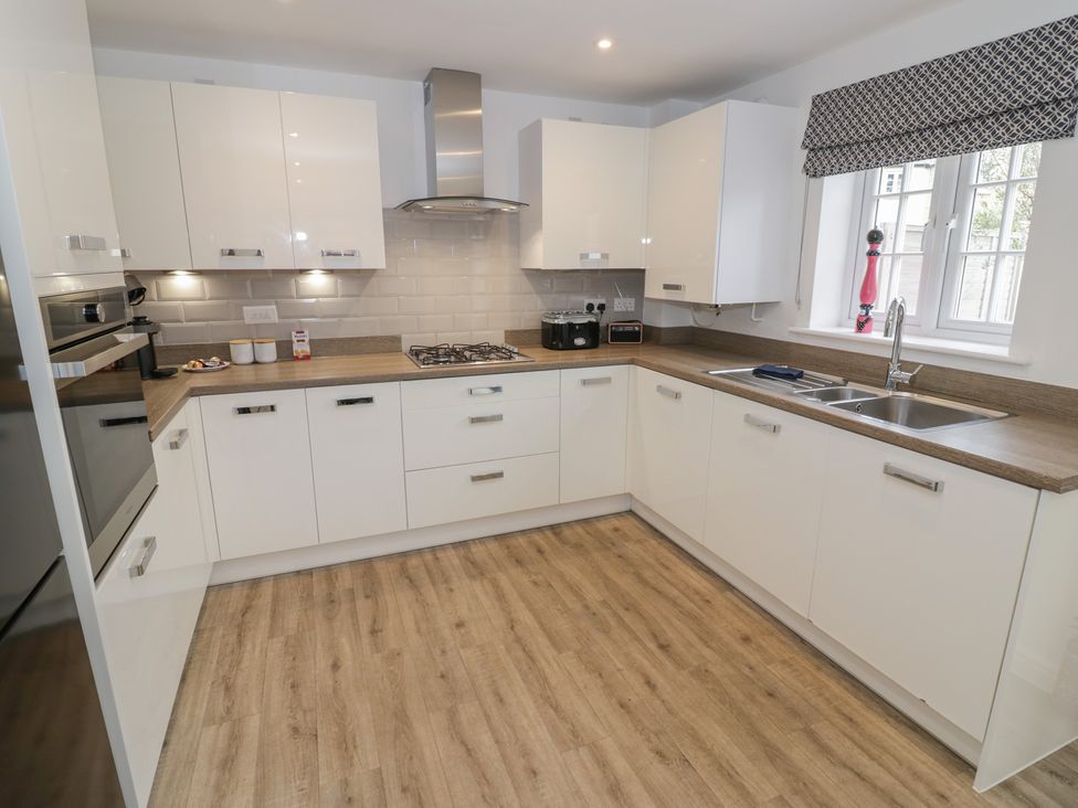 A kitchen with cabinets and appliances at Silverstone Paddock Retreat in Silverstone