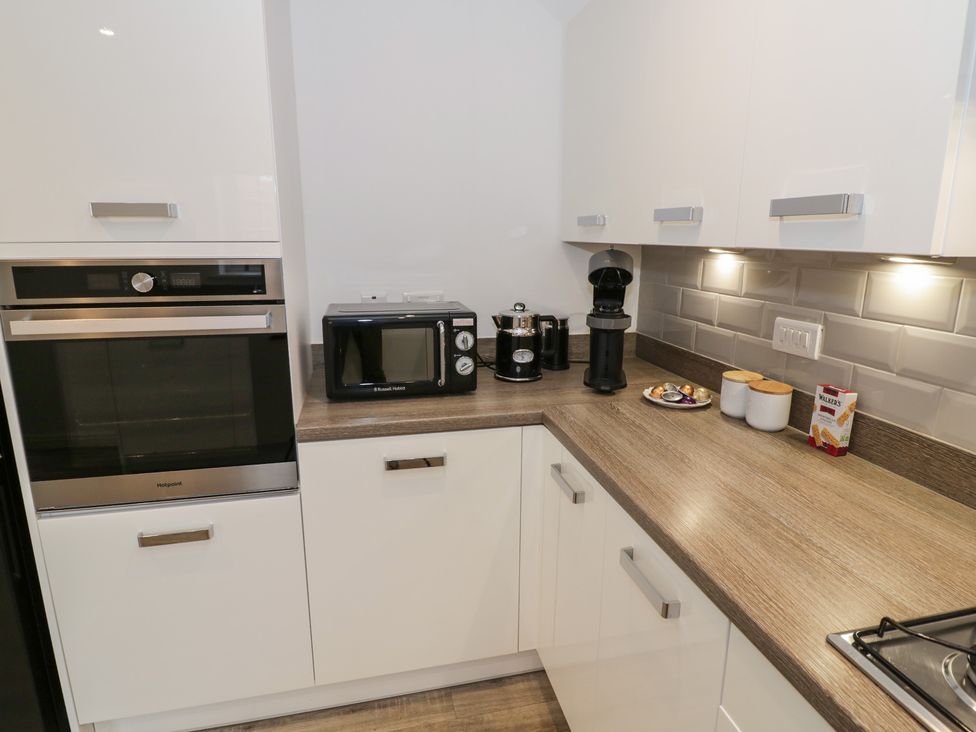 A kitchen with appliances and a countertop at Silverstone Paddock Retreat in Silverstone