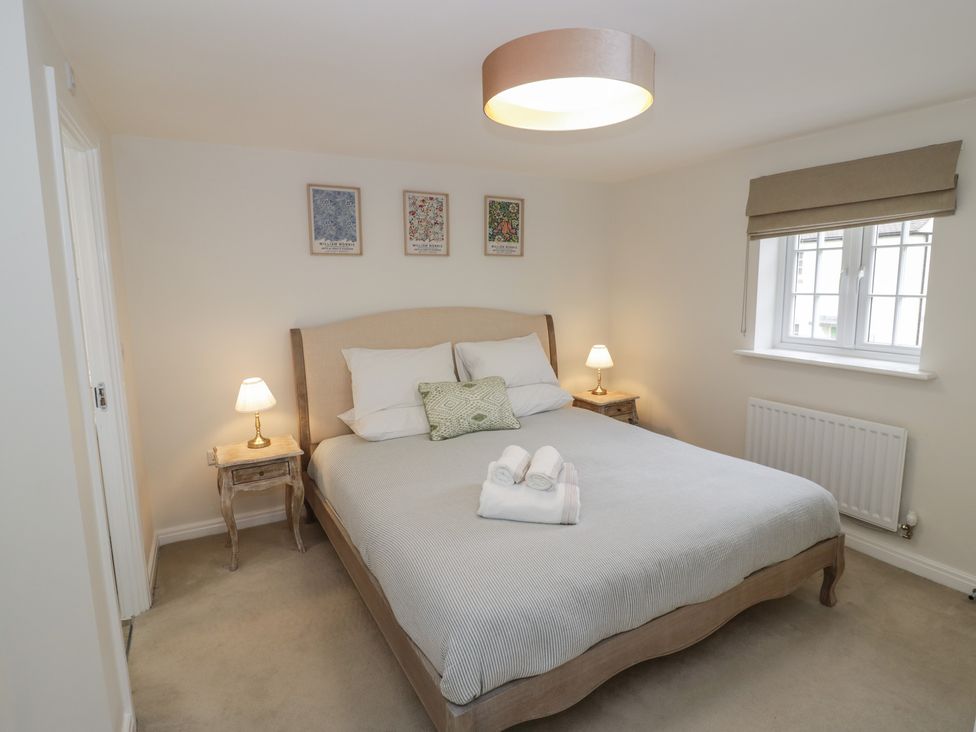 A bedroom with a bed and bedside lamps at Silverstone Paddock Retreat Silverstone