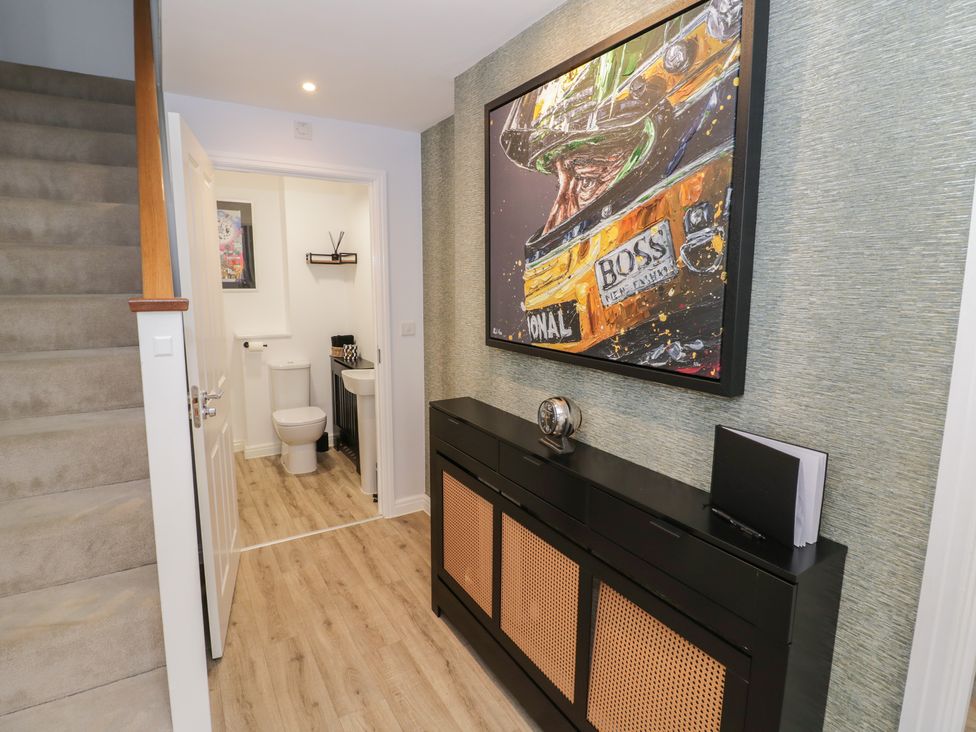 A hallway with stairs and a toilet at Silverstone Paddock Retreat in Silverstone