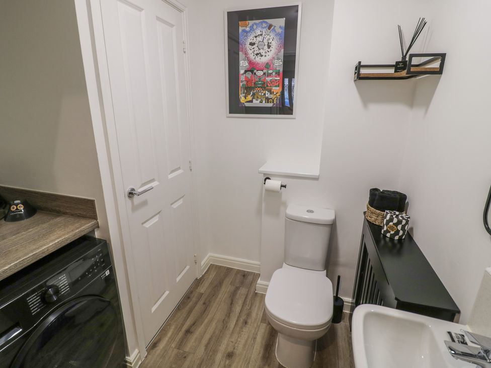 A bathroom with a toilet and washbasin at Silverstone Paddock Retreat in Silverstone
