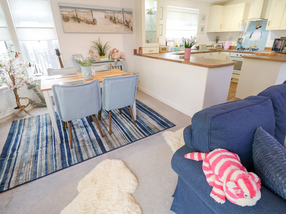 A living area with a dining table and chairs overlooking the kitchen at The Sanctuary Badgers Retreat Holiday Park near Catterick Garrison, North Yorkshire