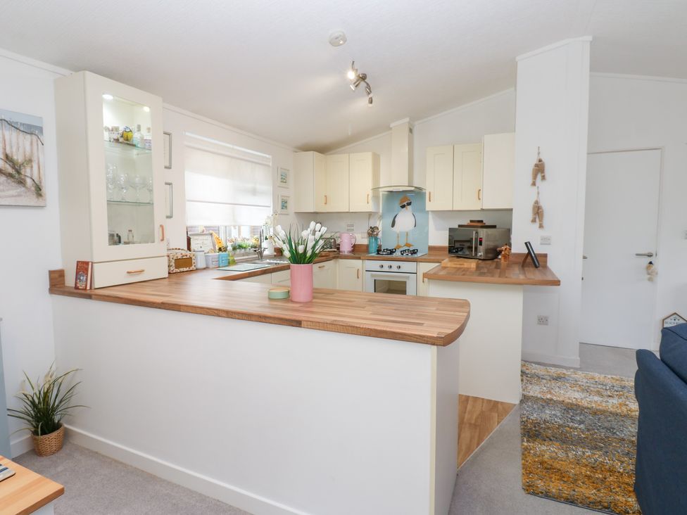 A kitchen with a stovetop and sink at The Sanctuary Badgers Retreat Holiday Park near Catterick Garrison North Yorkshire