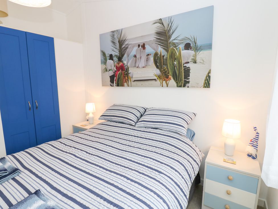 A bedroom with a bed and a wardrobe at The Sanctuary Badgers Retreat Holiday Park near Catterick Garrison, North Yorkshire