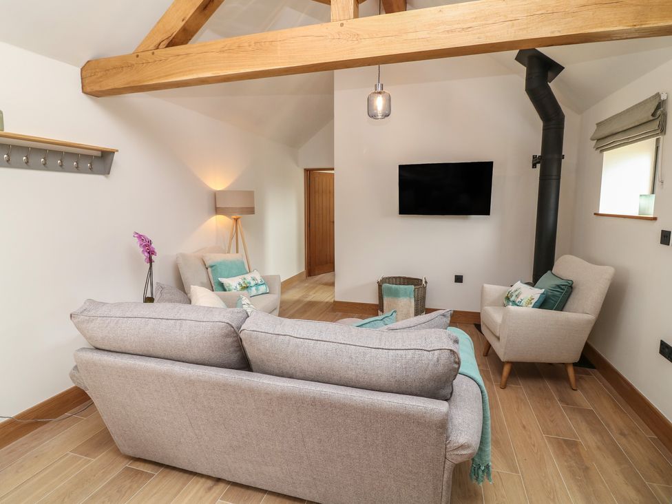 A living room with a sofa and television at Tawny Barn in Woodhall Spa