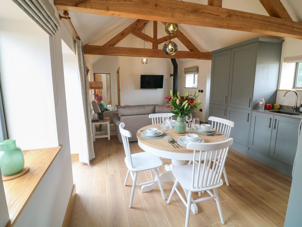 A dining room with a table and chairs at Tawny Barn in Woodhall Spa