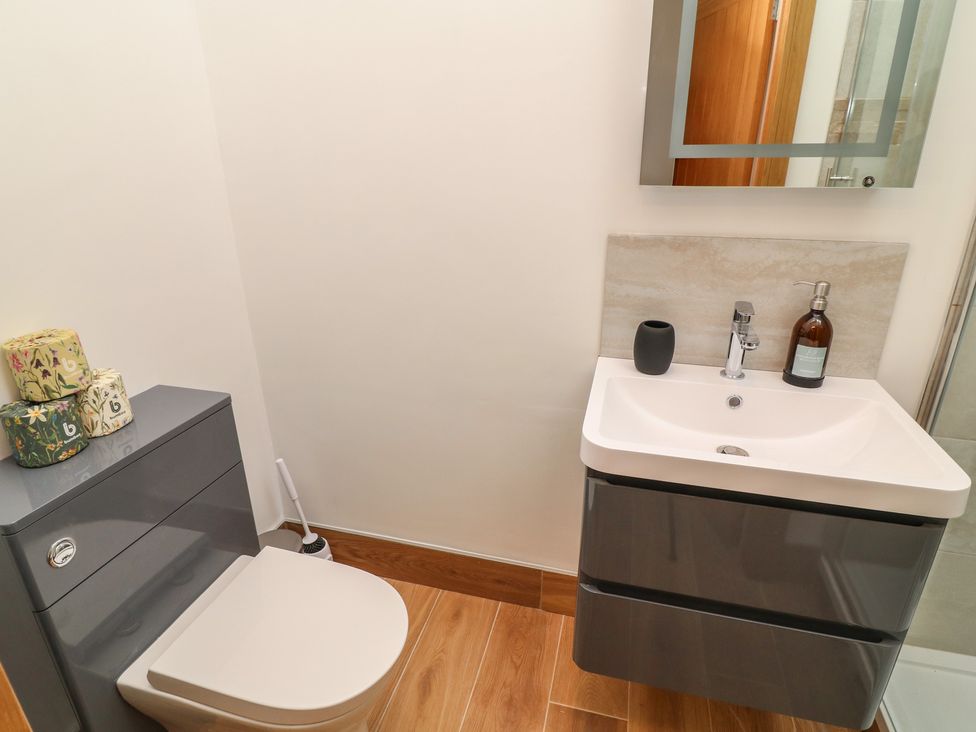 A bathroom with a toilet and sink at Tawny Barn in Woodhall Spa