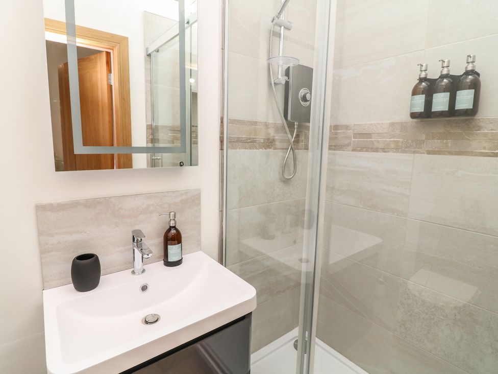 A bathroom with a shower and sink at Tawny Barn in Woodhall Spa