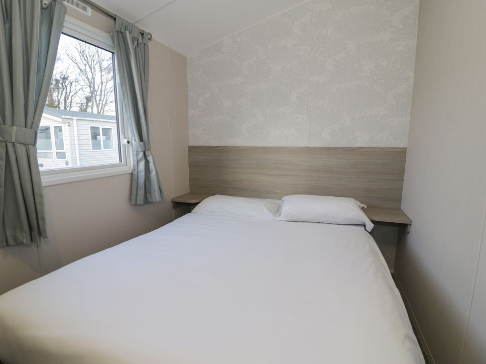 A bedroom with a bed and window at Lido Gold 120 in Prestatyn