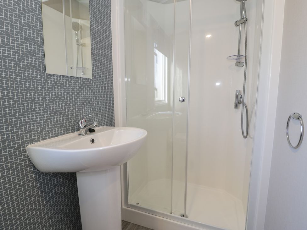 A bathroom with a sink and a shower at Lido Gold 120 in Prestatyn