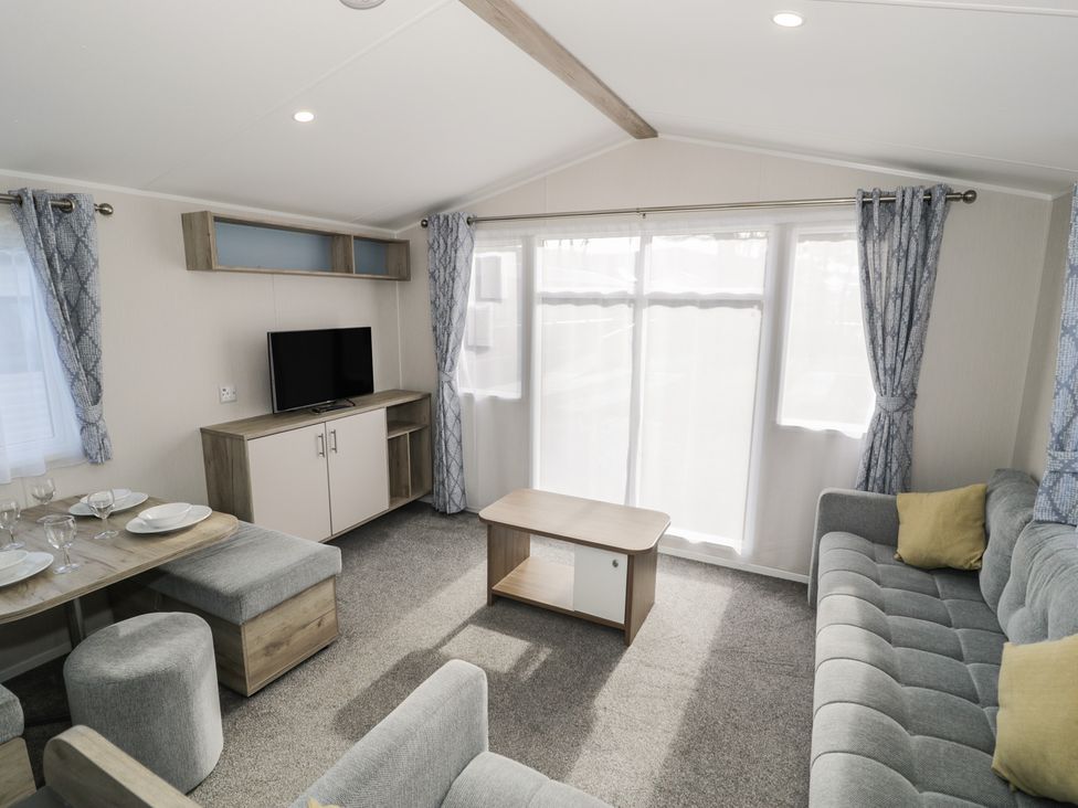 A living room with a television and seating area at Lido Gold 205 Prestatyn