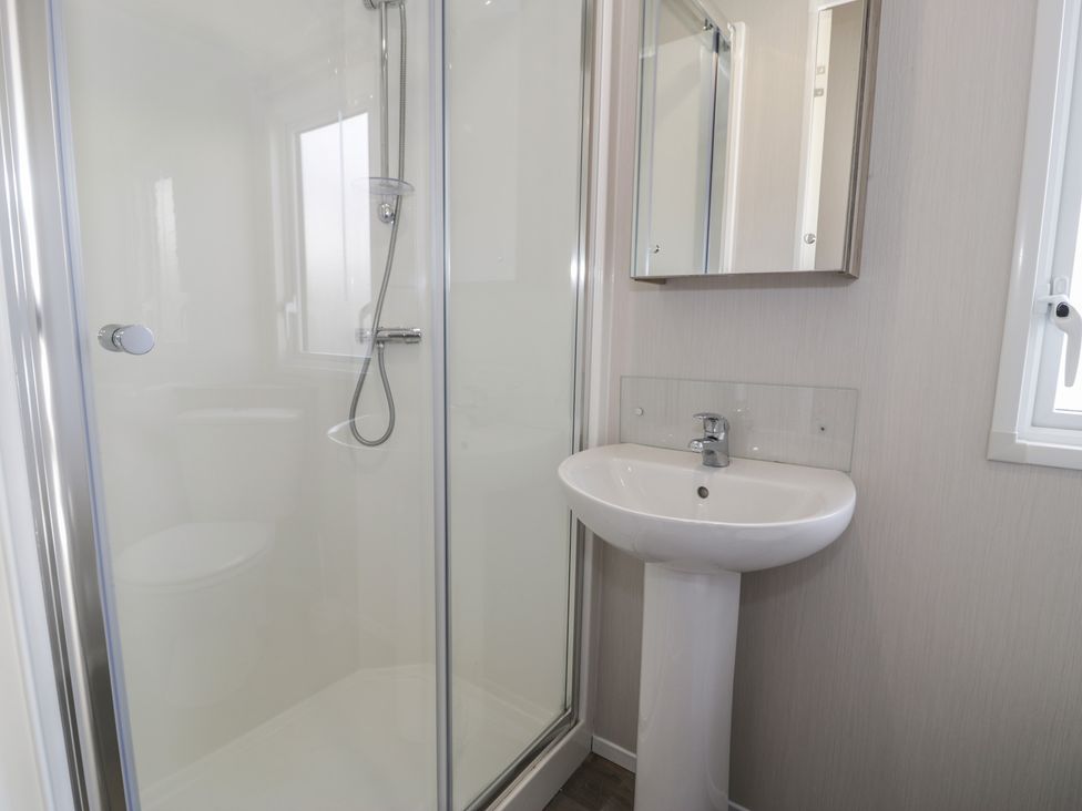 A bathroom with a shower and washbasin at Lido Gold 273 in Prestatyn