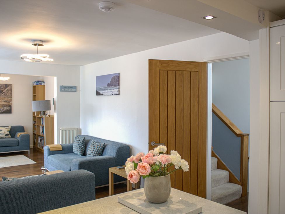 A living room with a sofa and bookshelf at Maceley in Kingsbridge