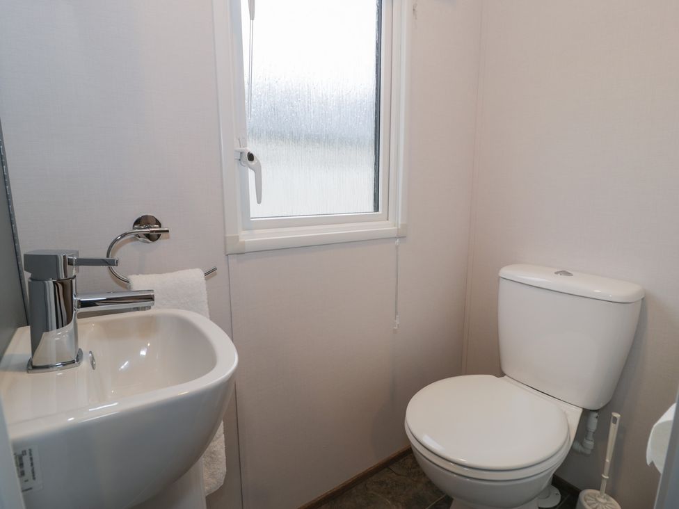 A bathroom with a sink and toilet at Woodlands Gold (WO40) in Ruthin